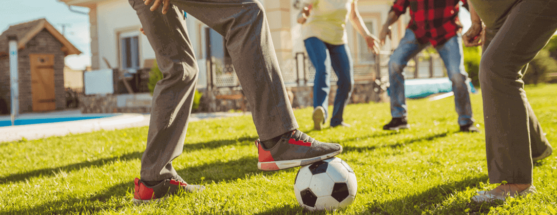 Kids kicking around a soccer ball in the yard