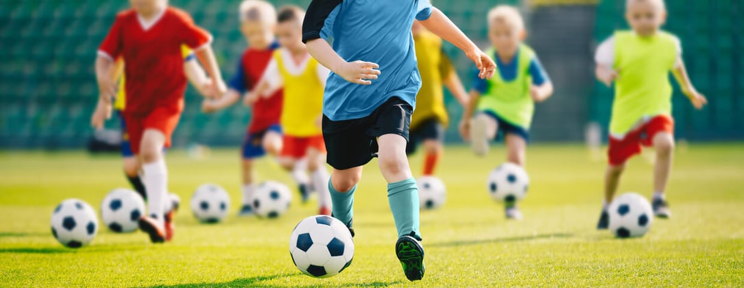 children playing soccer outside